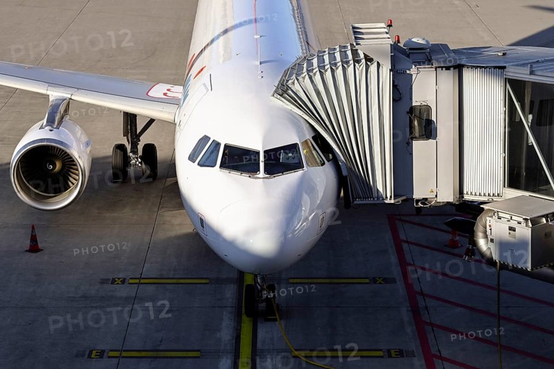 Aircraft Swiss with docked passenger boarding bridge