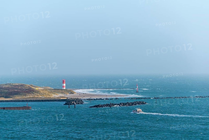 Dune with lighthouse on the beach