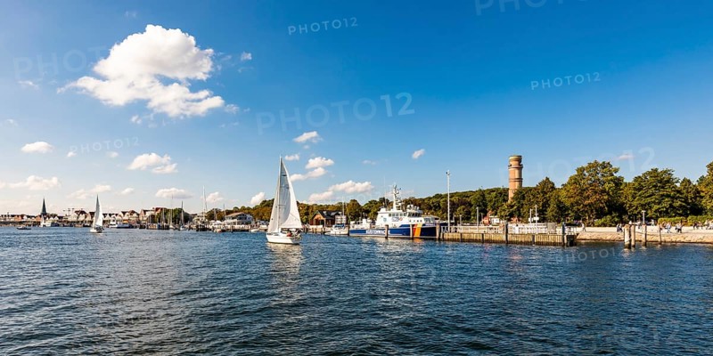 Sailing boats on the river Trave in front of the Trave promenade