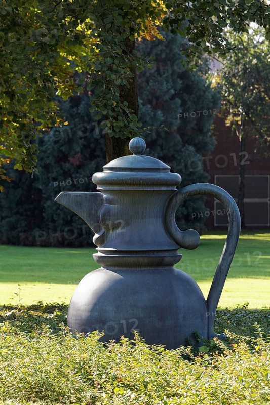 Metal sculpture coffee pot with face