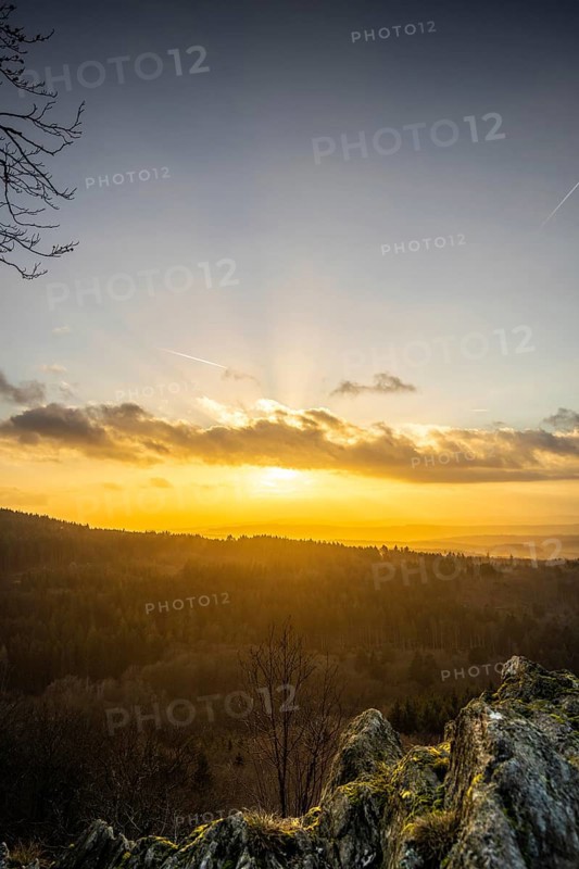 A Dramatic Sunset in the Evening with Clouds over a Valley in the Forest