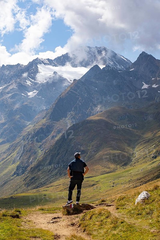 Hiker looking into the mountain massif of the Oetztal Alps in the rear Passeier Valley