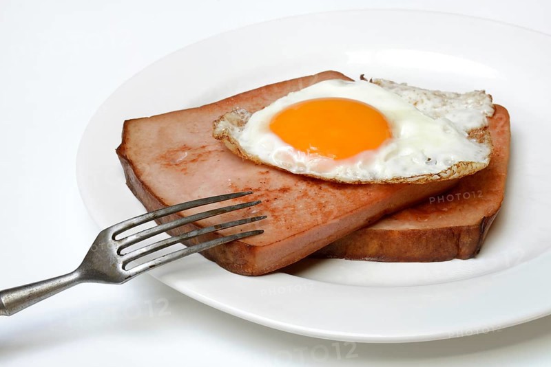Two slices of meat loaf with fried egg on plate