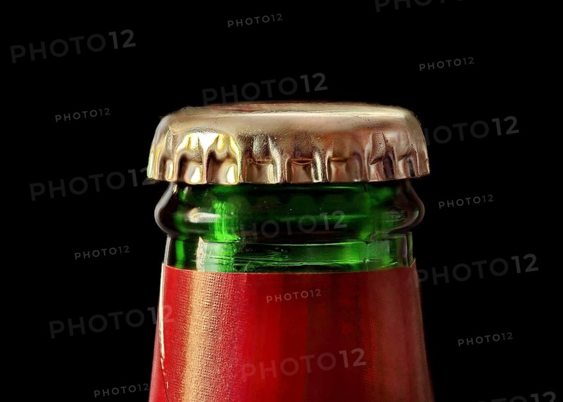 Green beer bottle with gold coloured crown cork
