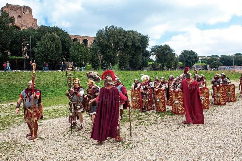 Traditional group of Roman legionaries in historical uniform equipment practising in Circus Maximus