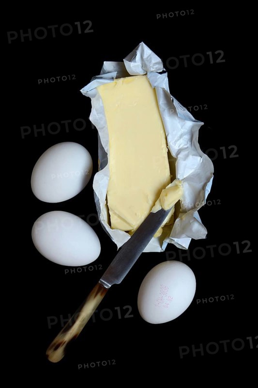 Butter in opened packaging and eggs