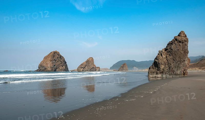 Sandy beach beach with sea and big rocks