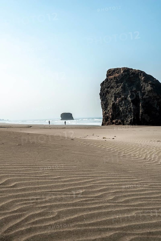 Sandy beach beach with sea and big rocks