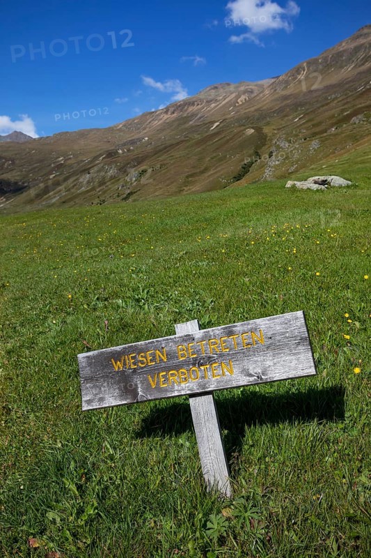 Alpine pasture Wooden sign Meadow no trespassing