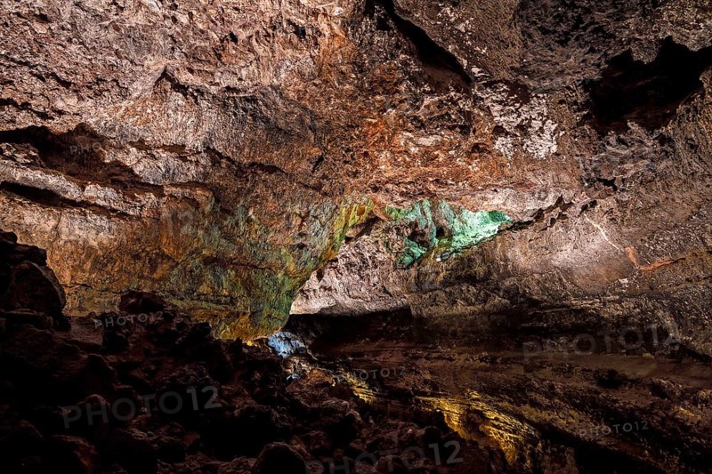 Colourfully illuminated areas of the Cueva de los Verdes
