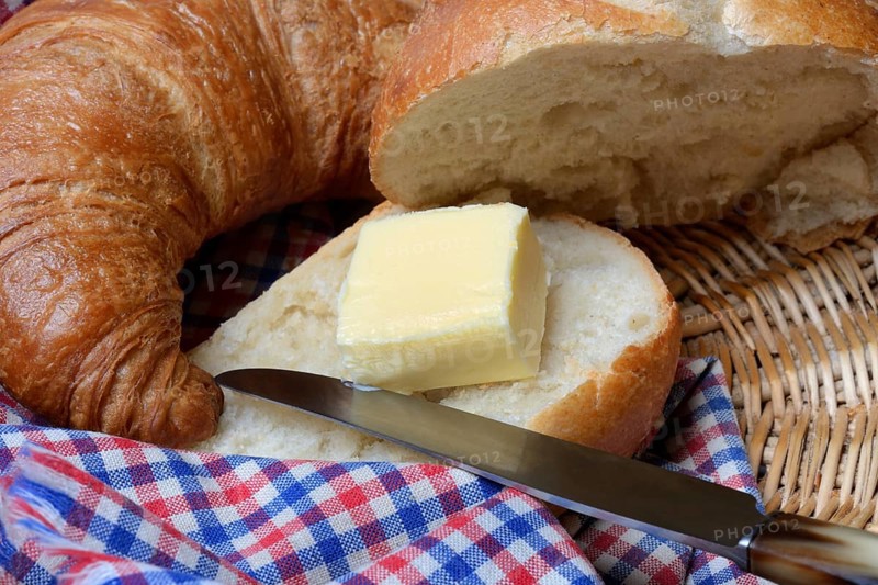 A piece of butter on a roll