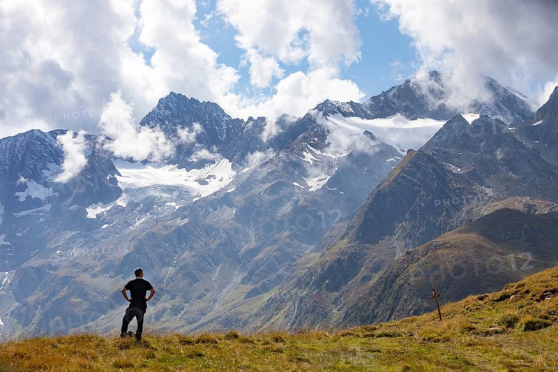 Hiker looking into the mountain massif of the Oetztal Alps in the rear Passeier Valley