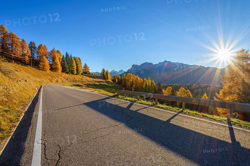 Mountain road with sun in autumn