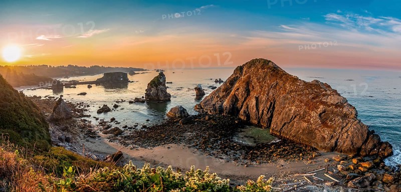 View of sea and sandy beach Harris Beach with rocks at sunrise