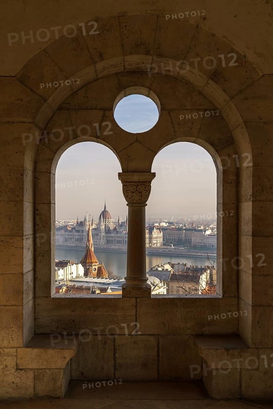 View through an arched window of the Fishermen's Bastion onto the Danube with the Parliament Building