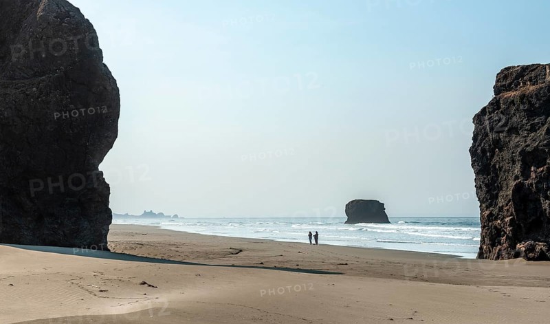 People on the beach between big rocks