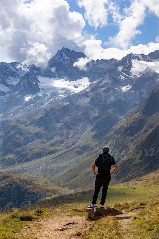 Hiker looking into the mountain massif of the Oetztal Alps in the rear Passeier Valley