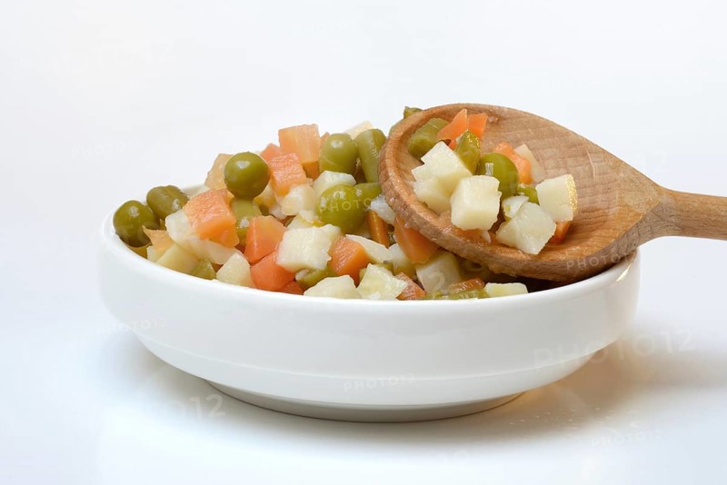 Ingredients for Russian salad in bowl