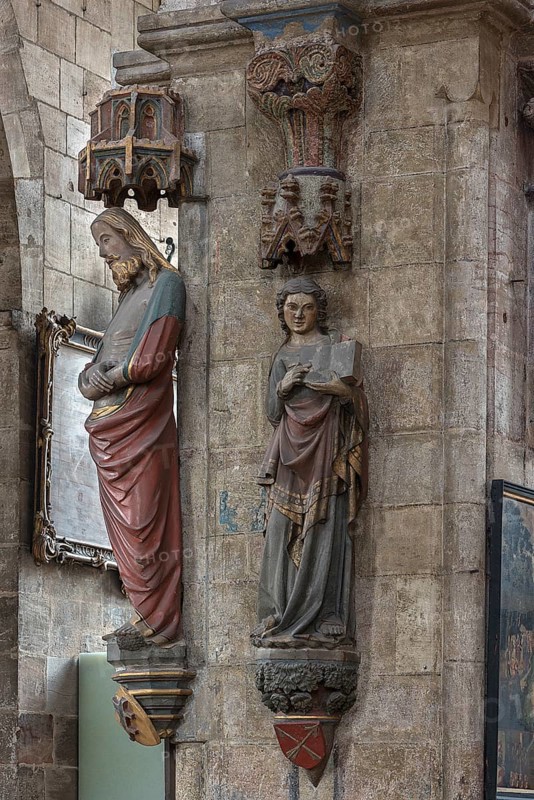Coloured sculptures of the Man of Sorrows on the left and holy St. Matthew on the right