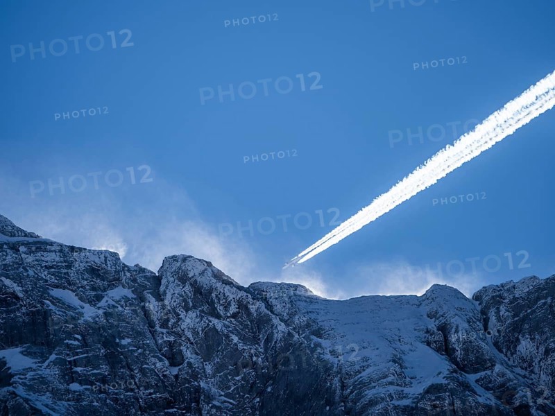 Plane over summit of the Hochtor Group in morning light