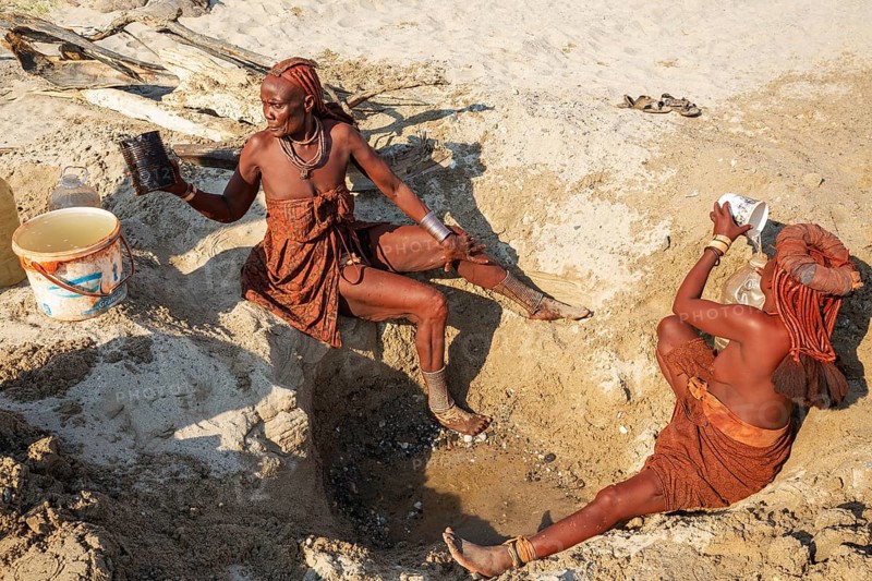 Himba women collecting water at a water hole