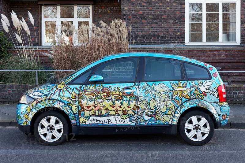Artistically painted Audi A2 parked in front of residential building