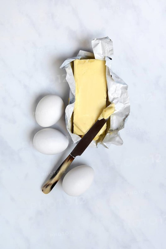 Butter in opened packaging and eggs