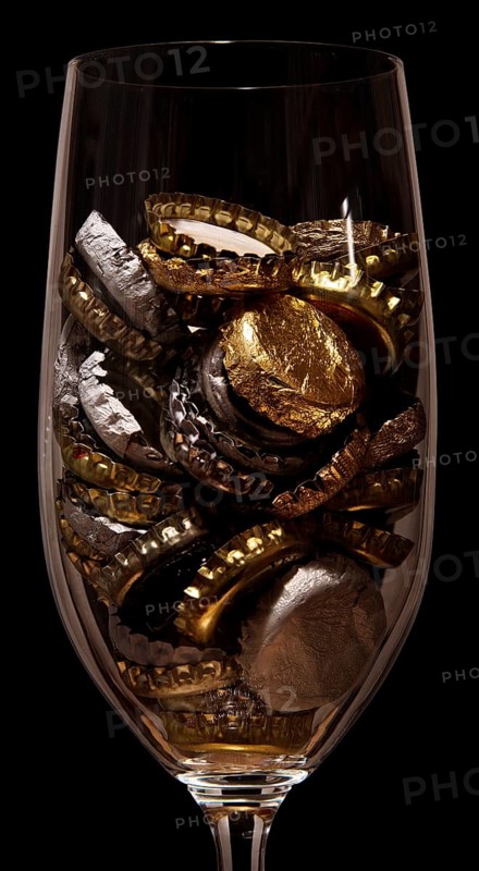 Crown caps collected in a beer glass