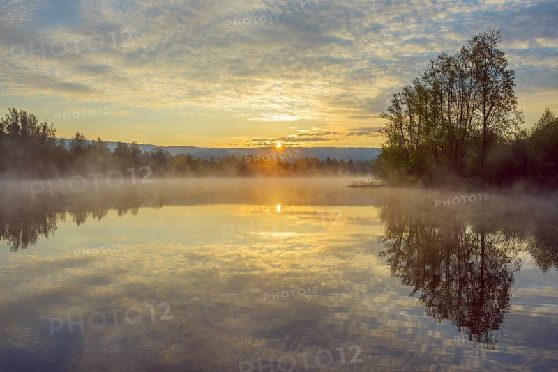 Lake with morning mist at sunrise