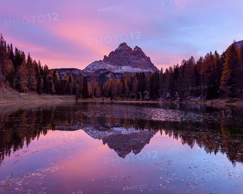 Antorno lake towards Tre Cime di Lavaredo mountain at dawn reflected in lake