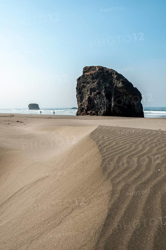 Sandy beach beach with sea and big rocks