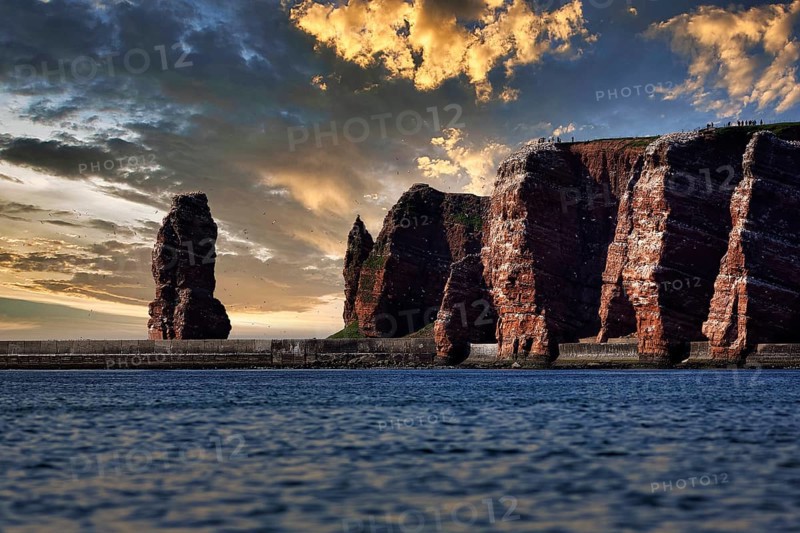 View from the sea to the rocky island of Helgoland with surf pillar Lange Anna