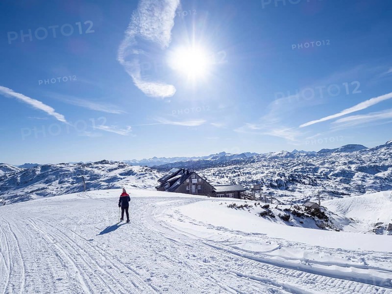 Snowshoe hiker in winter landscape in the high mountains