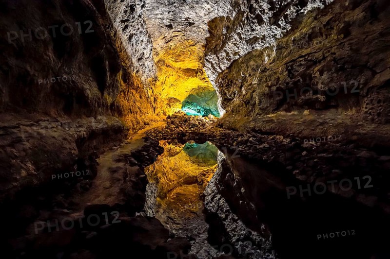 Colourfully illuminated areas of the Cueva de los Verdes