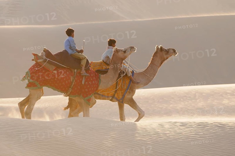 Camel riders at the longest sand dunes in India