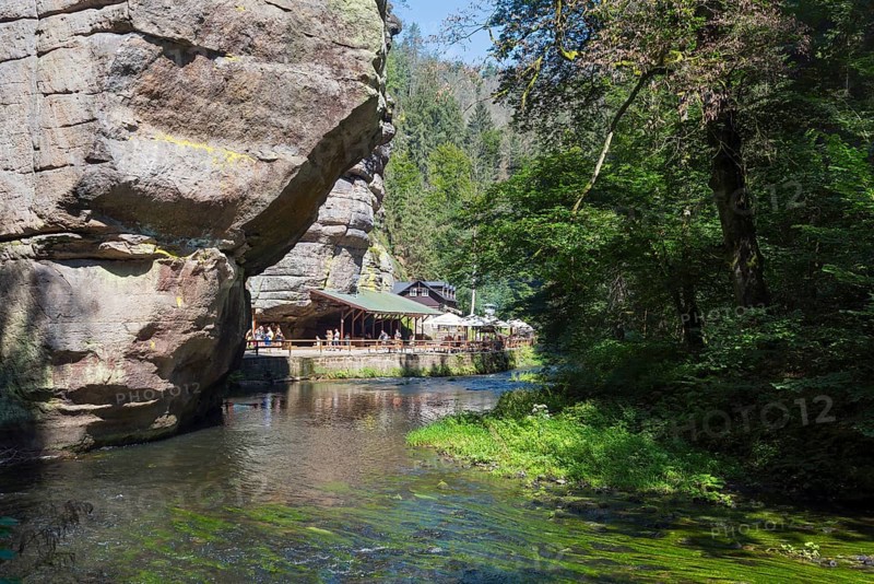 Resting place at the log cabin and rock walls in the Kamenice valley