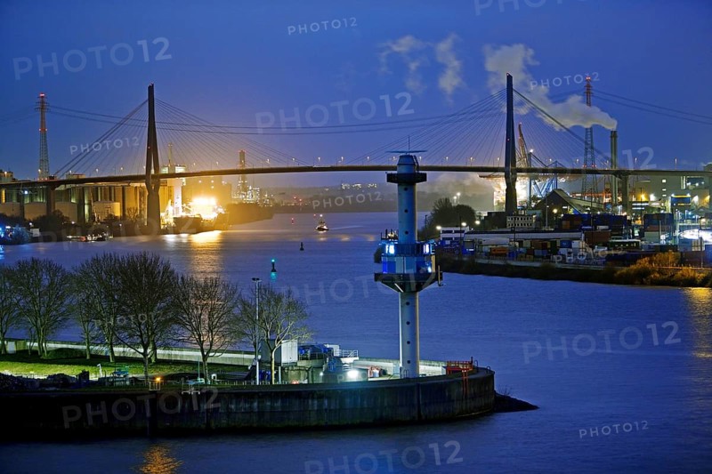 Radar tower with water level indicator in front of the Koehlbrand Bridge in the evening