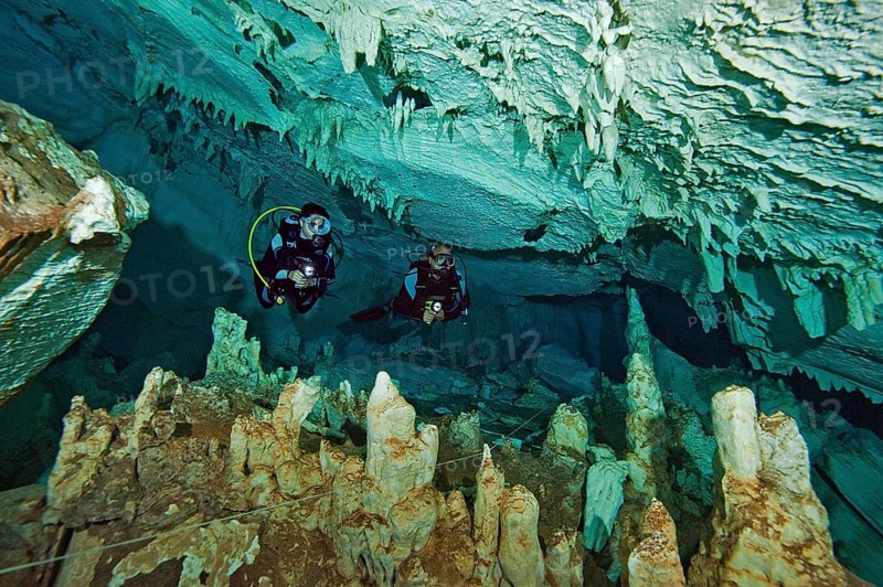 Scuba diver in easy-to-dive freshwater stalactite cave like Cenote