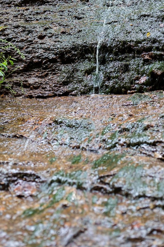 Water flowing down steep rock face