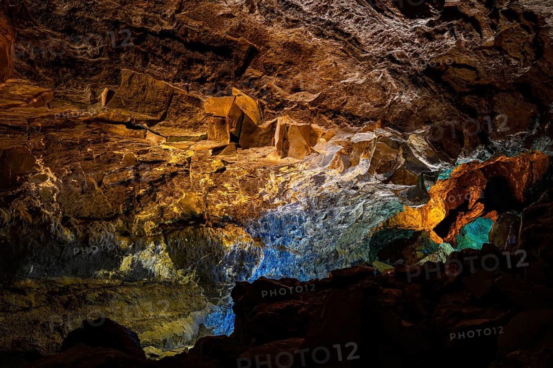 Colourfully illuminated areas of the Cueva de los Verdes