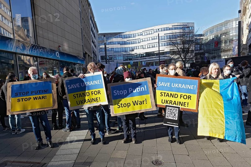 Demonstrators with protest placards against the Russian invasion of Ukraine