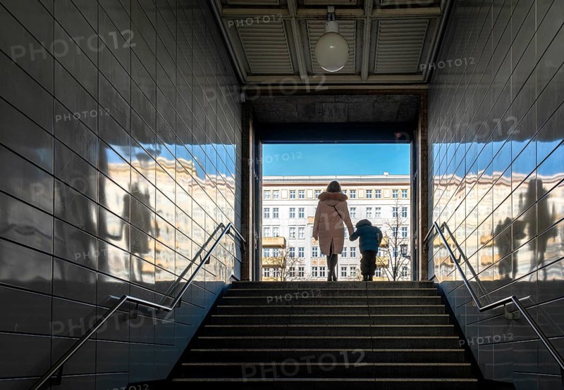 Passengers at the exit of the underground station Straussberger Platz