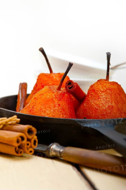 Poached pears delicious home made recipe ove white rustic wood table