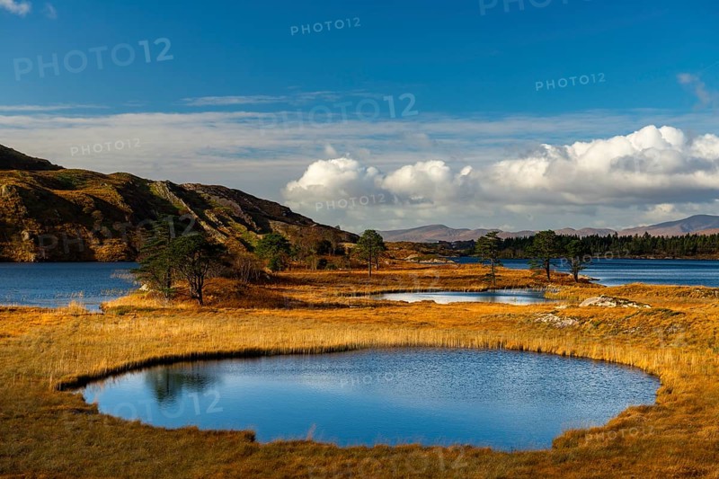 Lough Cloonee with cloudy sky in autumn landscape