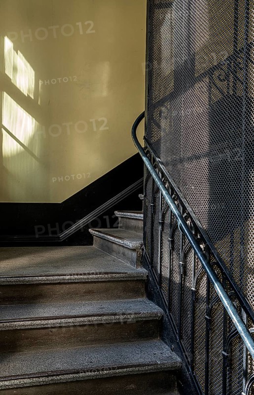 Staircase and grid on a historic lift in an old factory