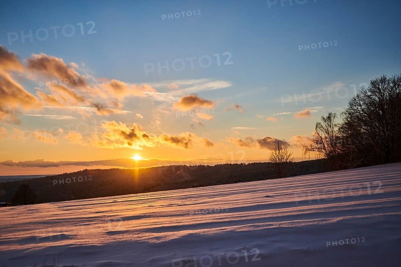 Sunset over a field covered with snow near Wiesent