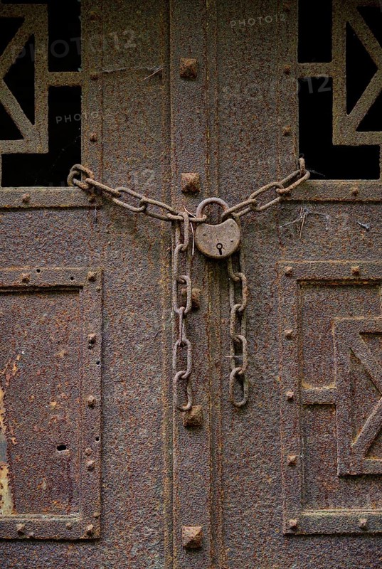 Rusty door with padlock at the Wilmersdorf forest cemetery