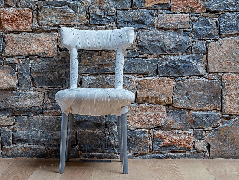 Designer chair standing in front of a clinker wall