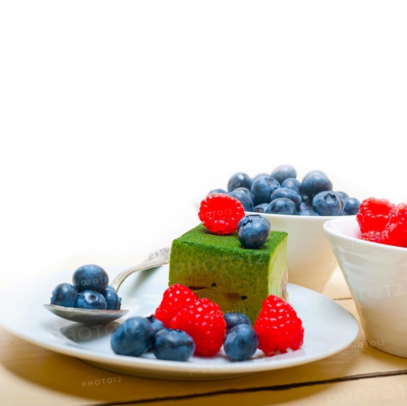 Green tea matcha mousse cake with raspberries and blueberries on top