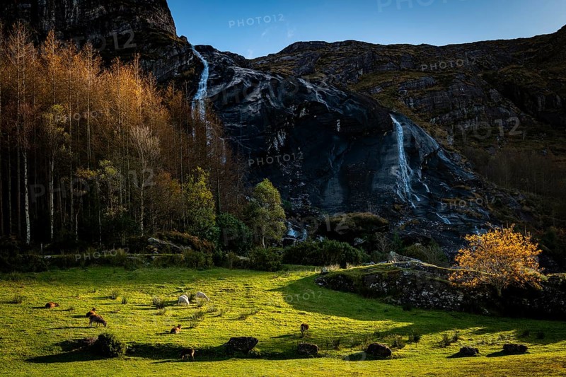Waterfall in autumn landscape